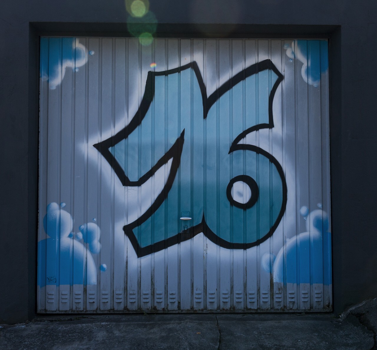 Number 16 graffiti on a garage door