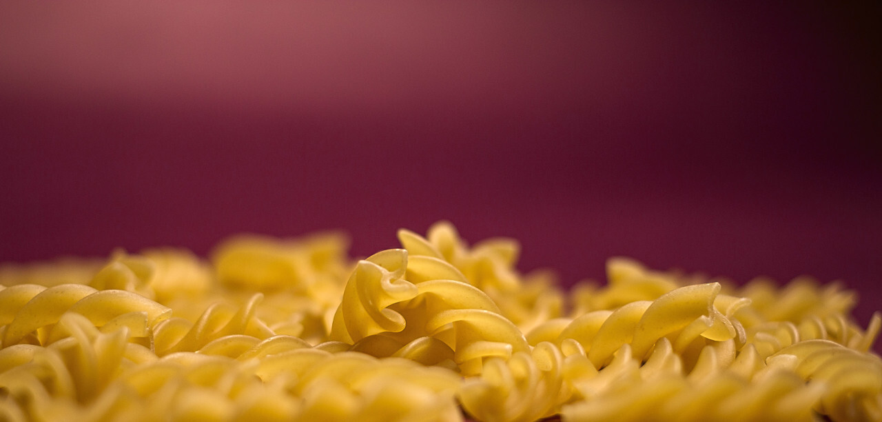 background of fusilli pasta noodles