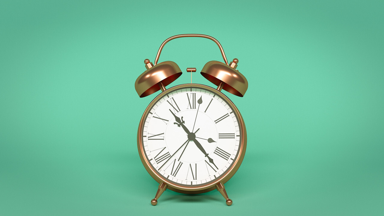 alarm clock isolated on green background