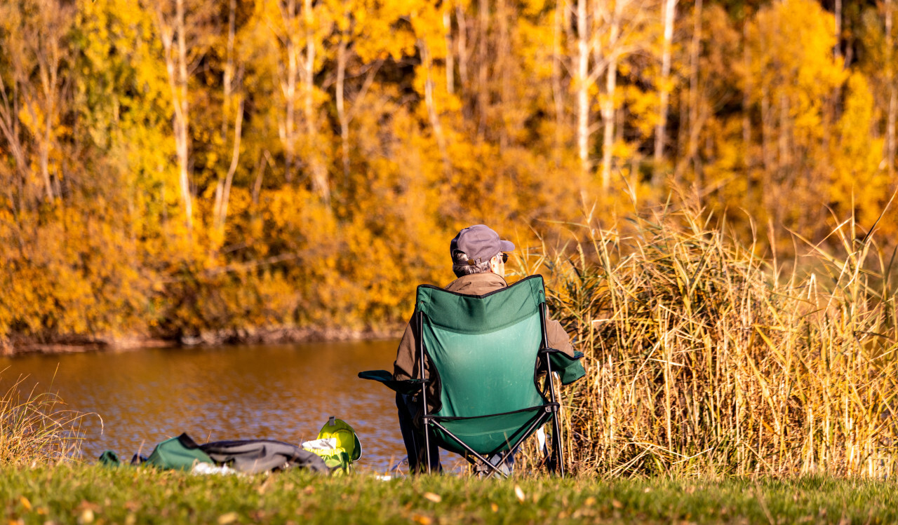 Angler sits by the lake