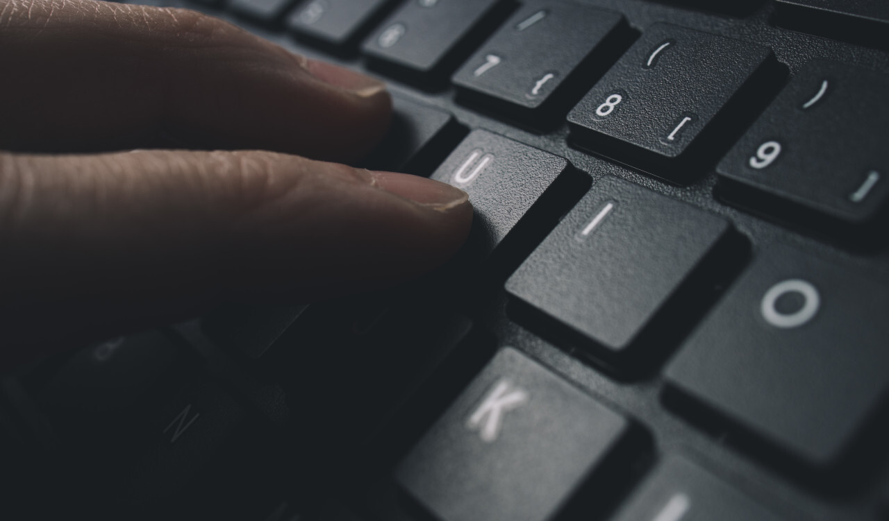 Male hands typing on computer keyboard