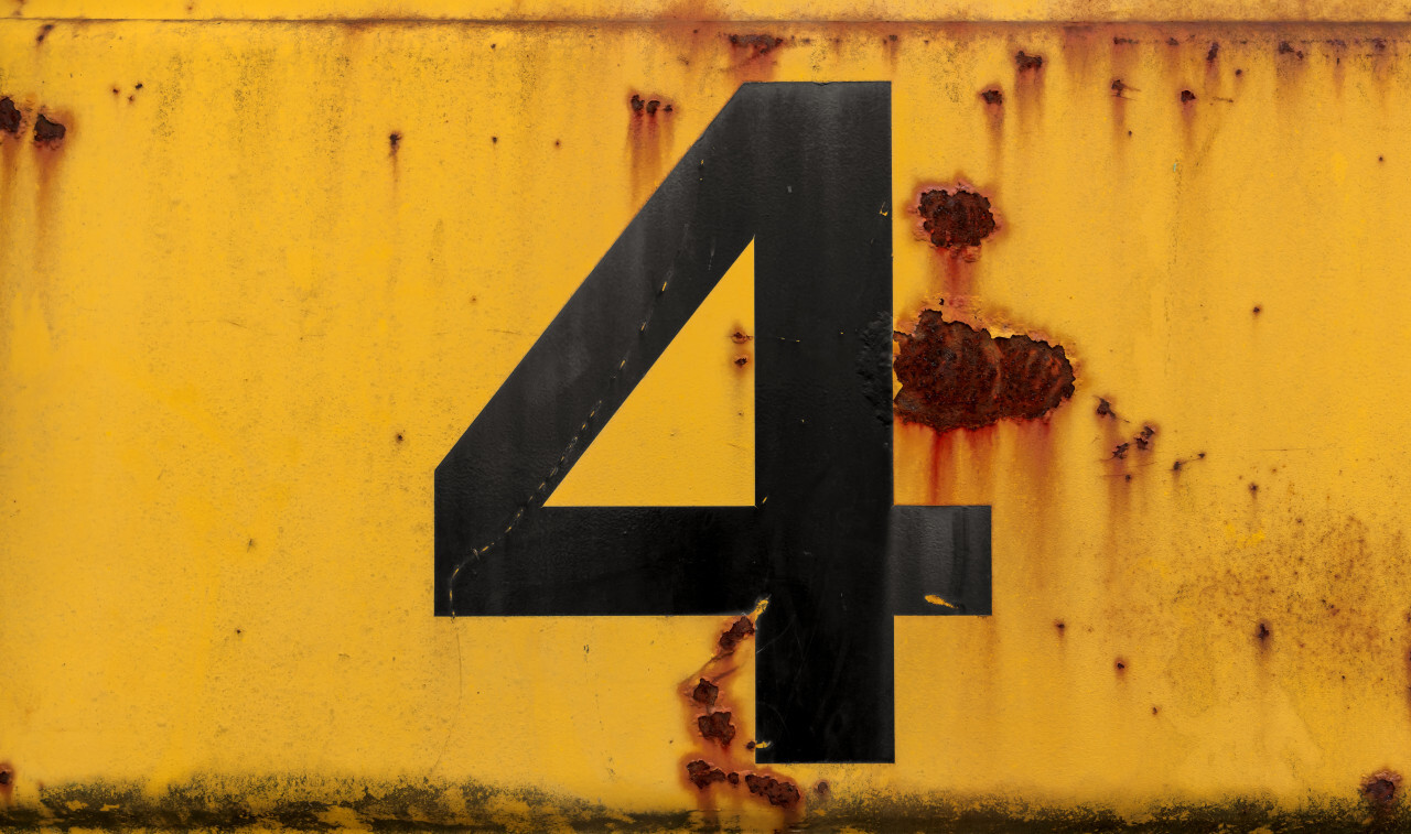 Number 4 (four) on a yellow metal wall