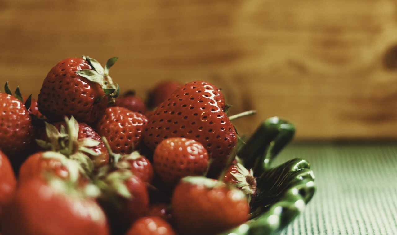 delicious red strawberries on a green plate