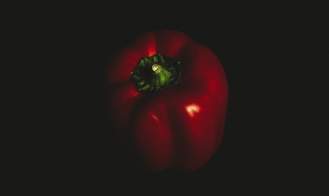 Red pepper on black background