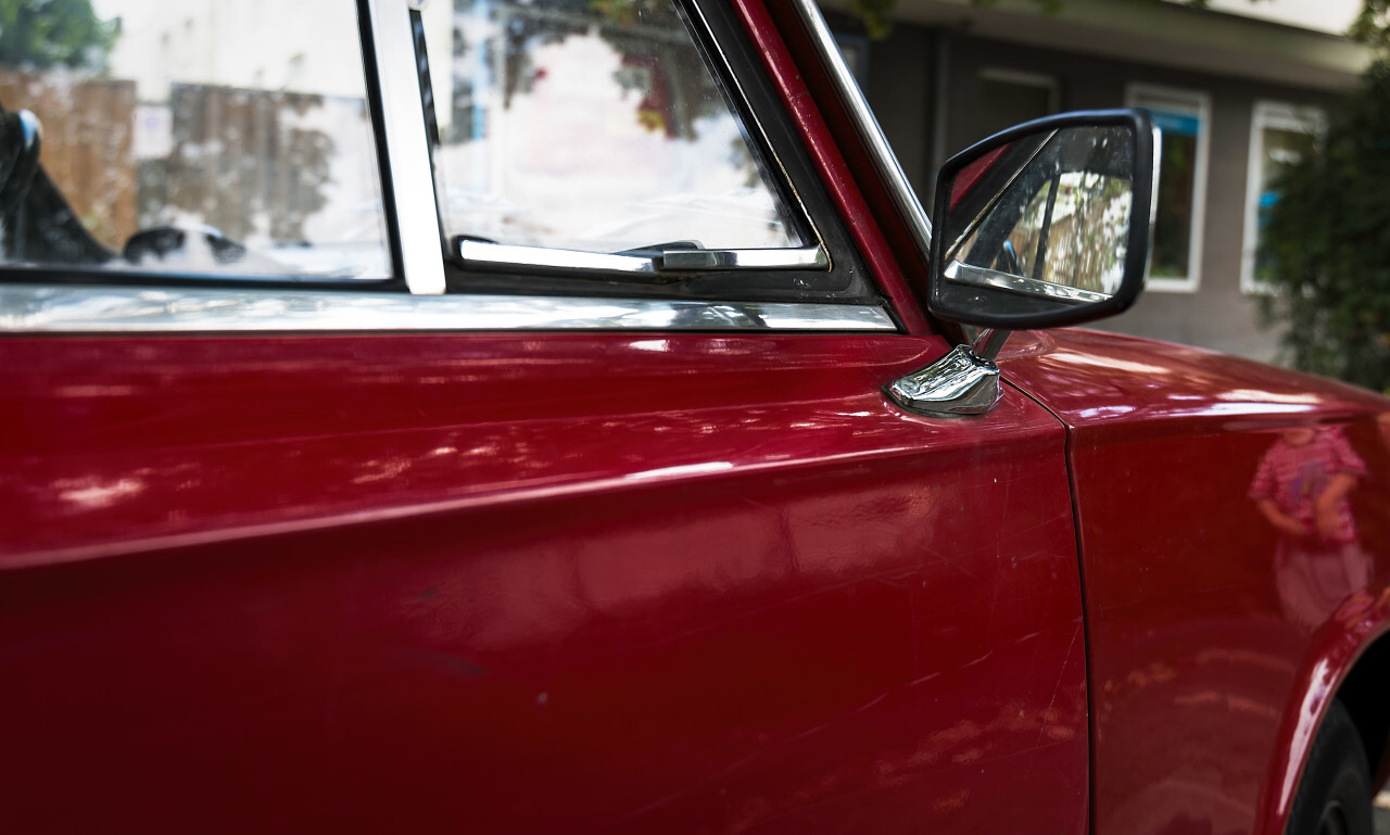 Side view of a red classic car