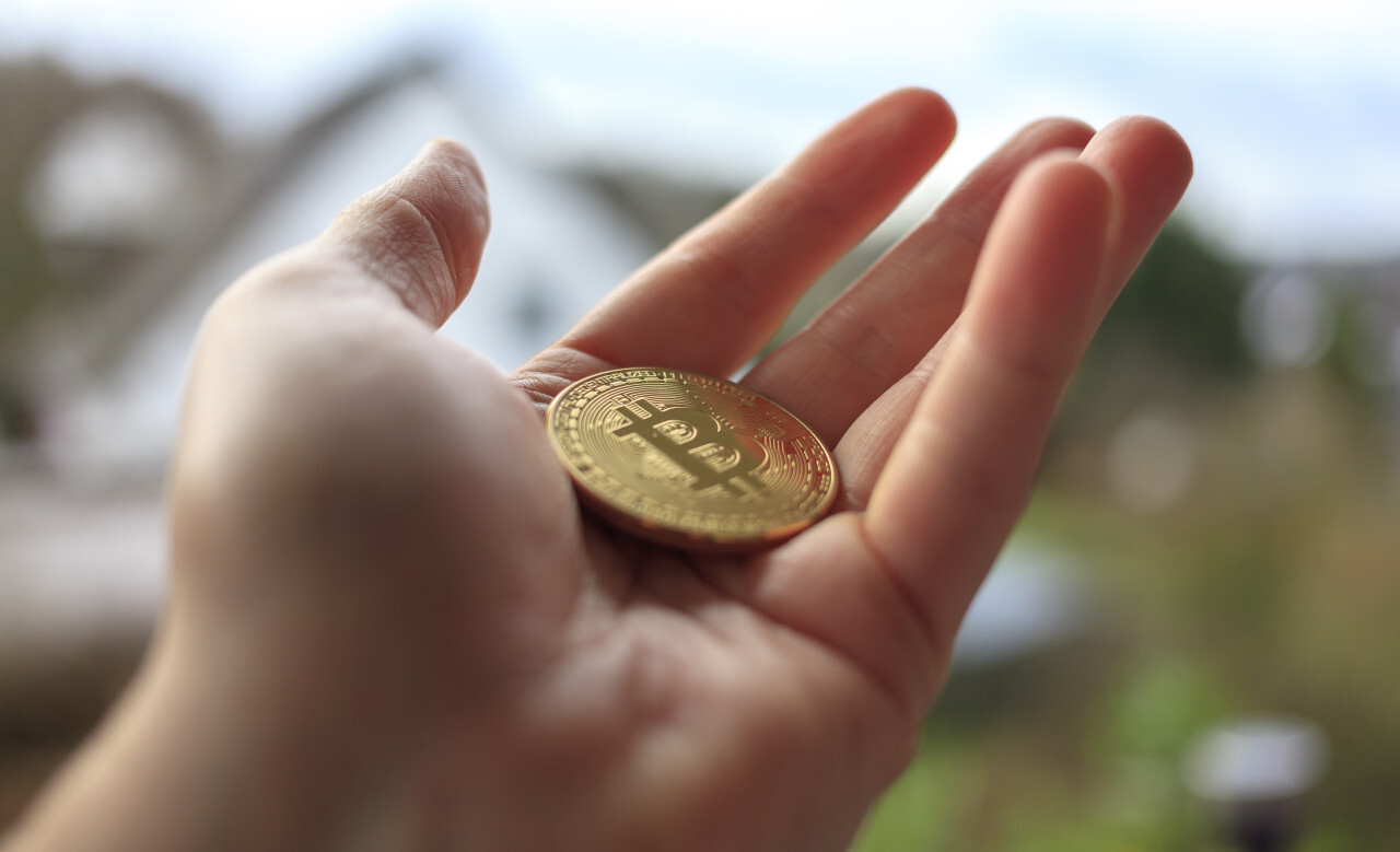 Close up of male hand holding Bitcoin