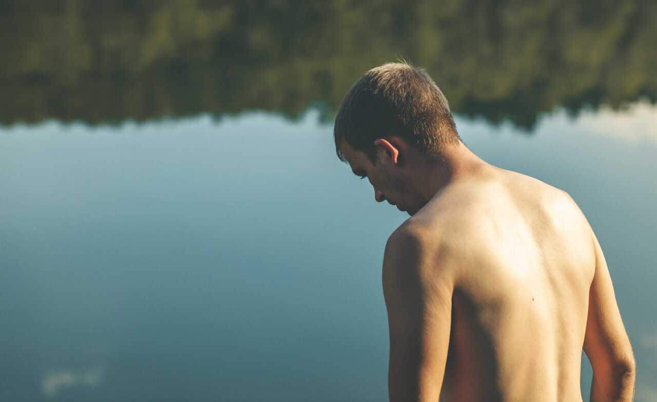 man in front of a lake