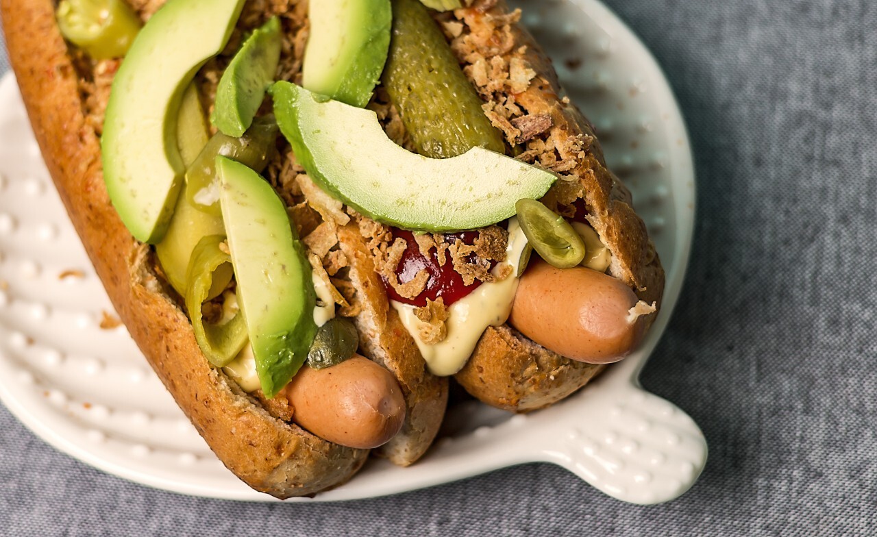 gourmet hot dogs with avocado slices