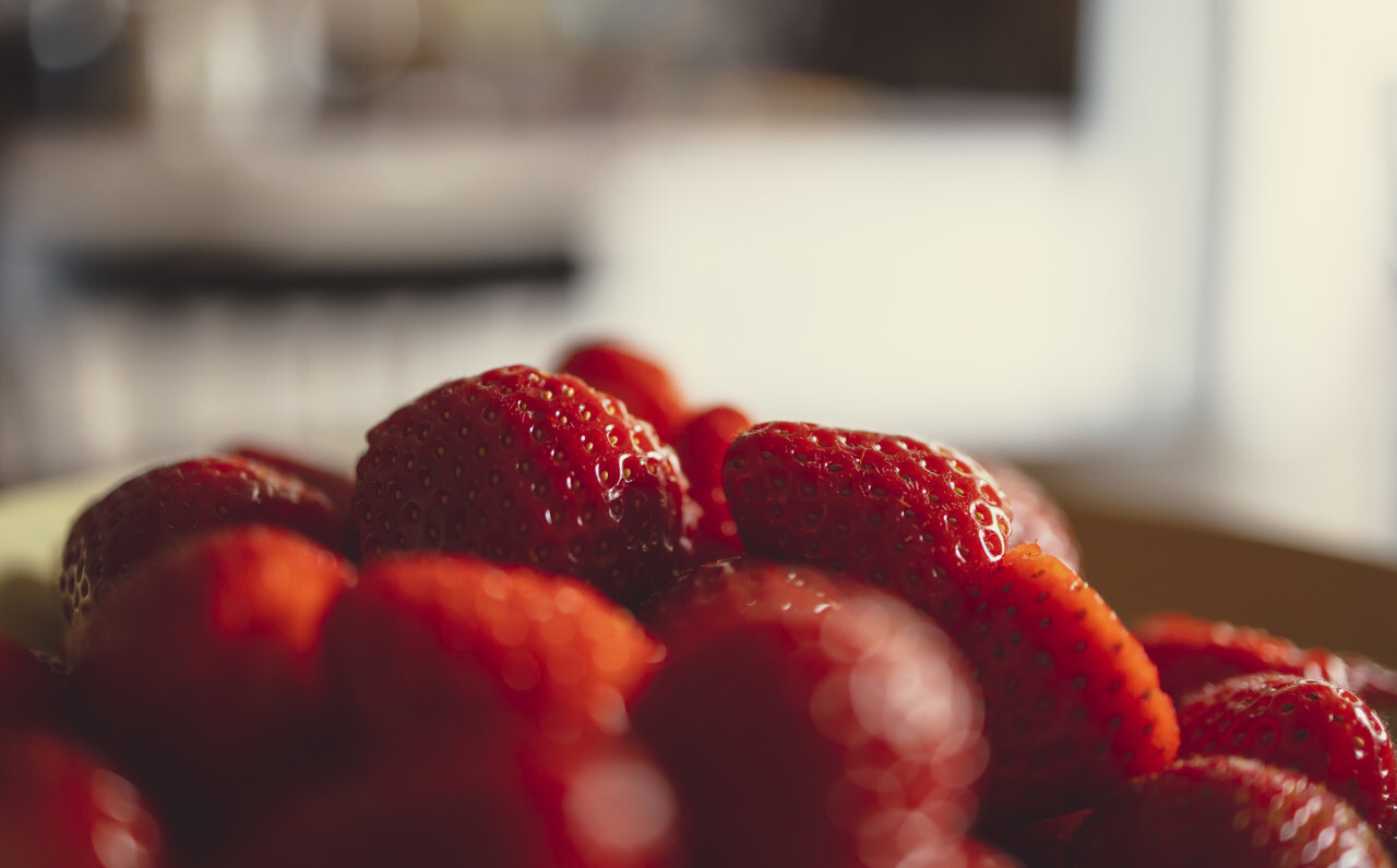 Close up view of strawberries on a plate in a modern kitchen