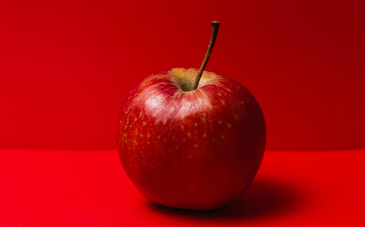 red apple red background