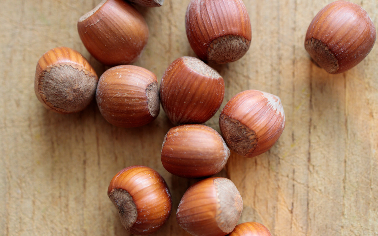 Hazelnuts on a light wooden board