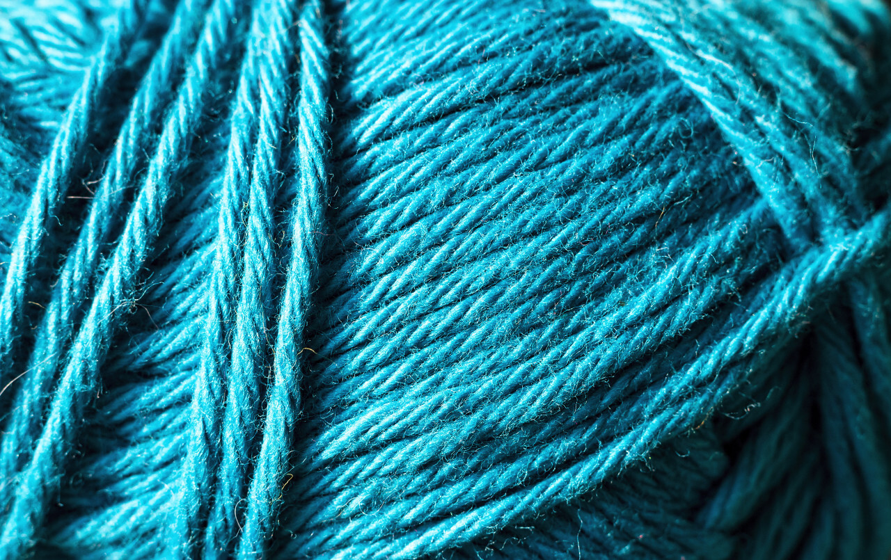 Close up the blue yarn thread as abstract background