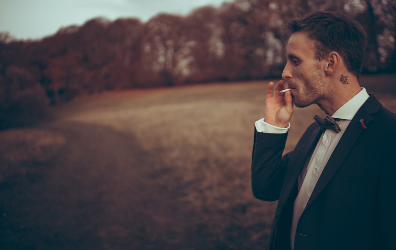 Stylish young businessman smoking