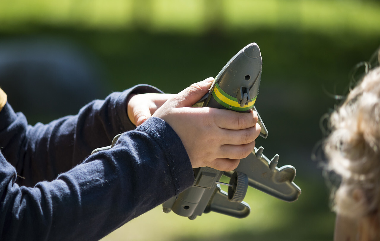 child plays with toy warplane