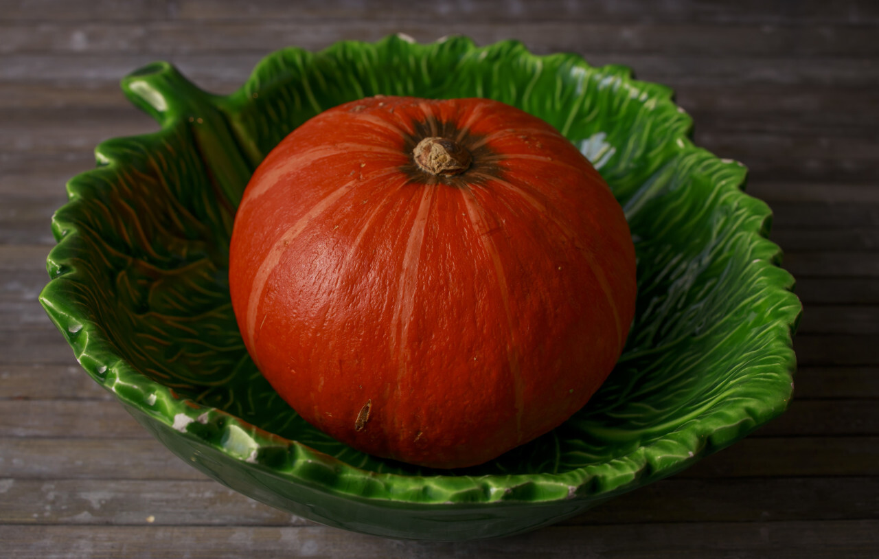 Whole pumpkin in a leaf-shaped bowl