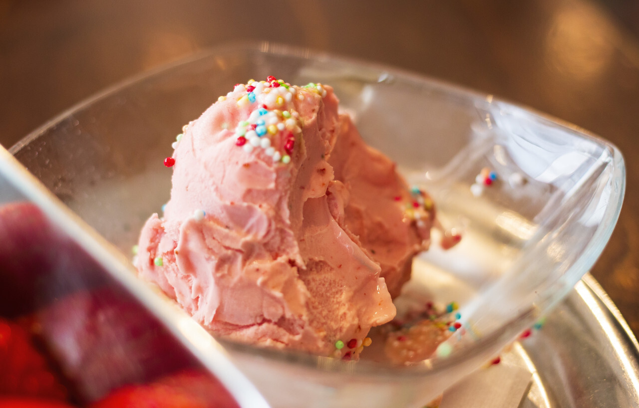 Strawberry ice cream with colorful sprinkles