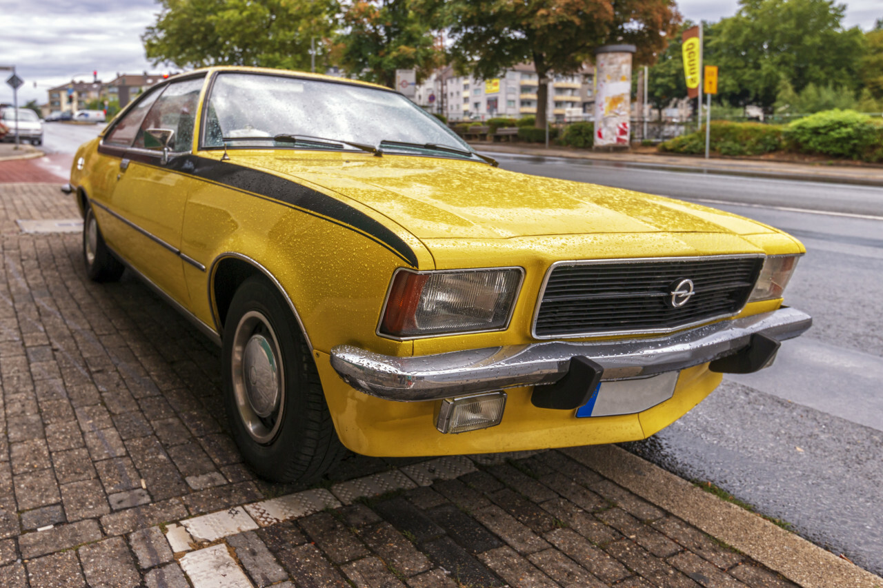 Beautiful old yellow car Opel Ascona A on a rainy day