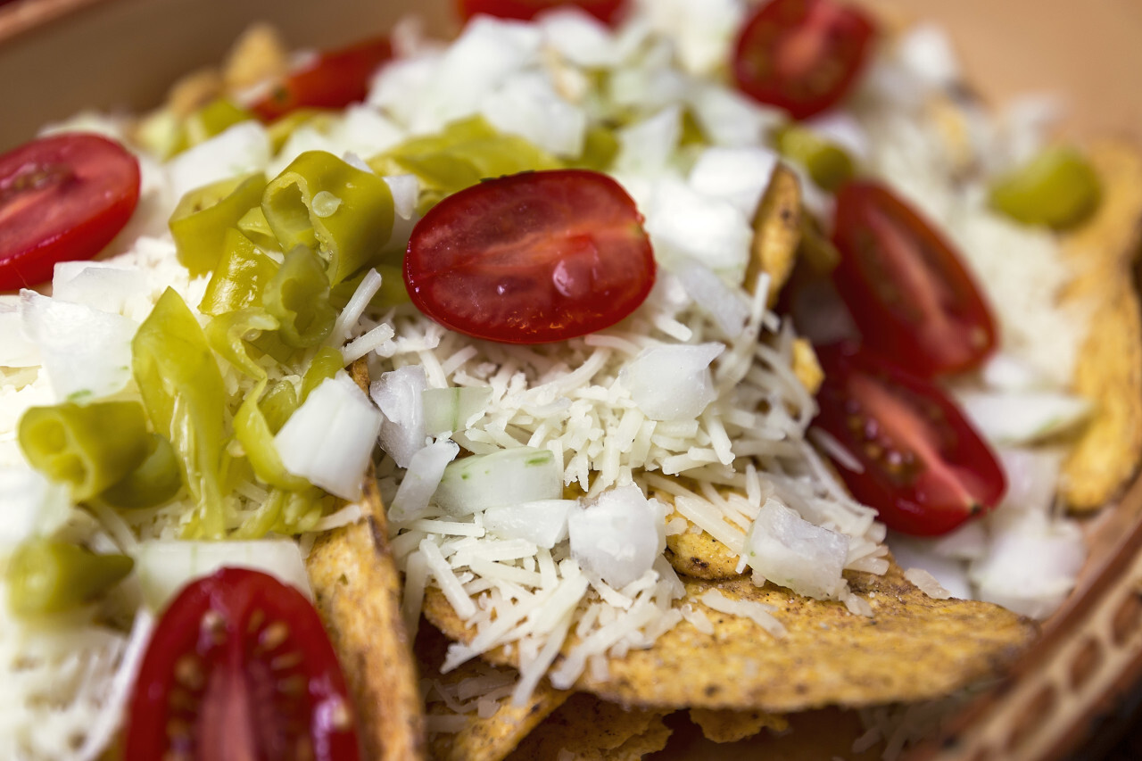 tortilla chips with tomato cheese and chili peppers