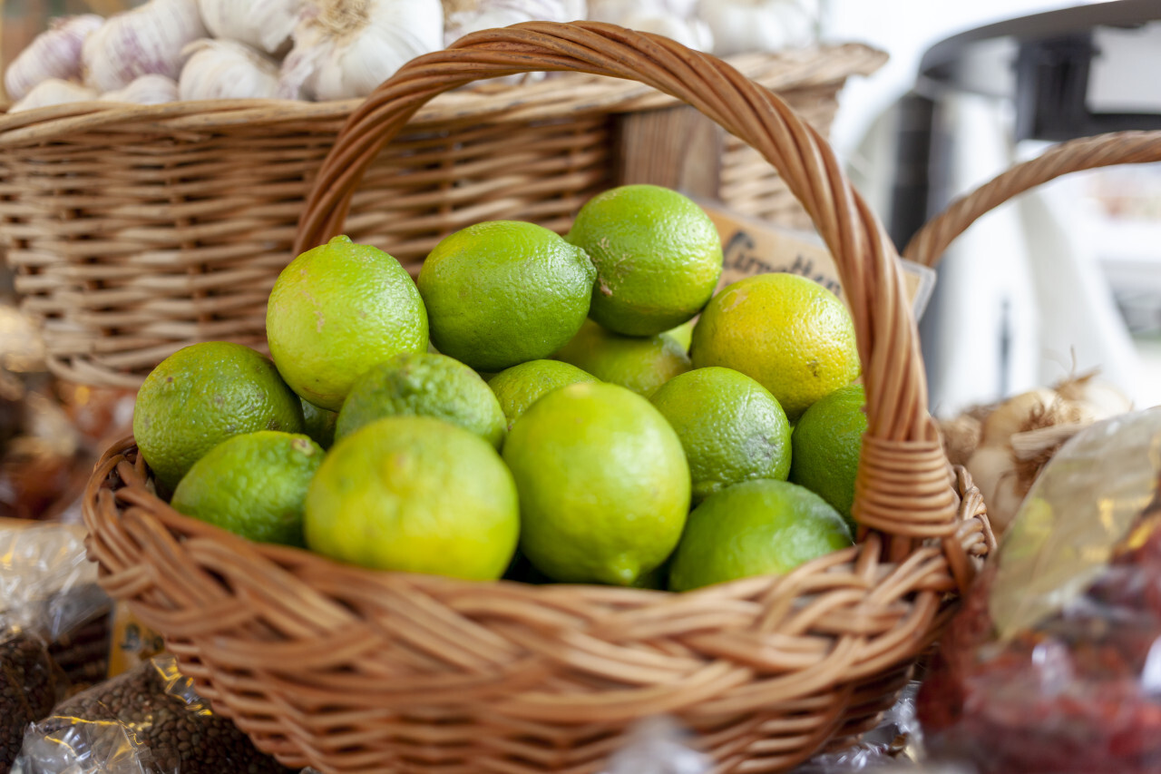 Wicker basket of limes on the market