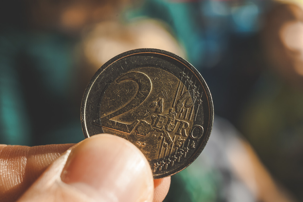 2 euro coin with scratches in hand