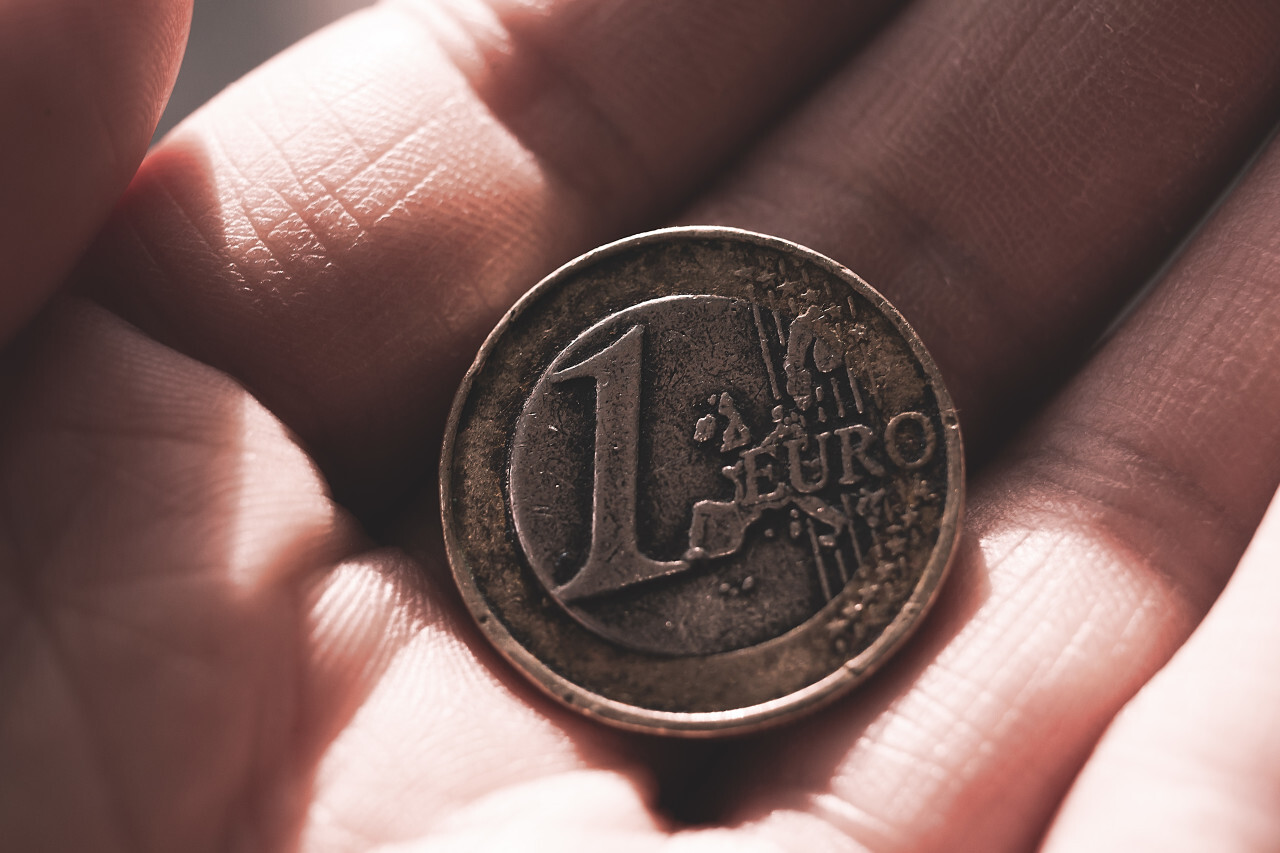 old used 1 euro coin in hand