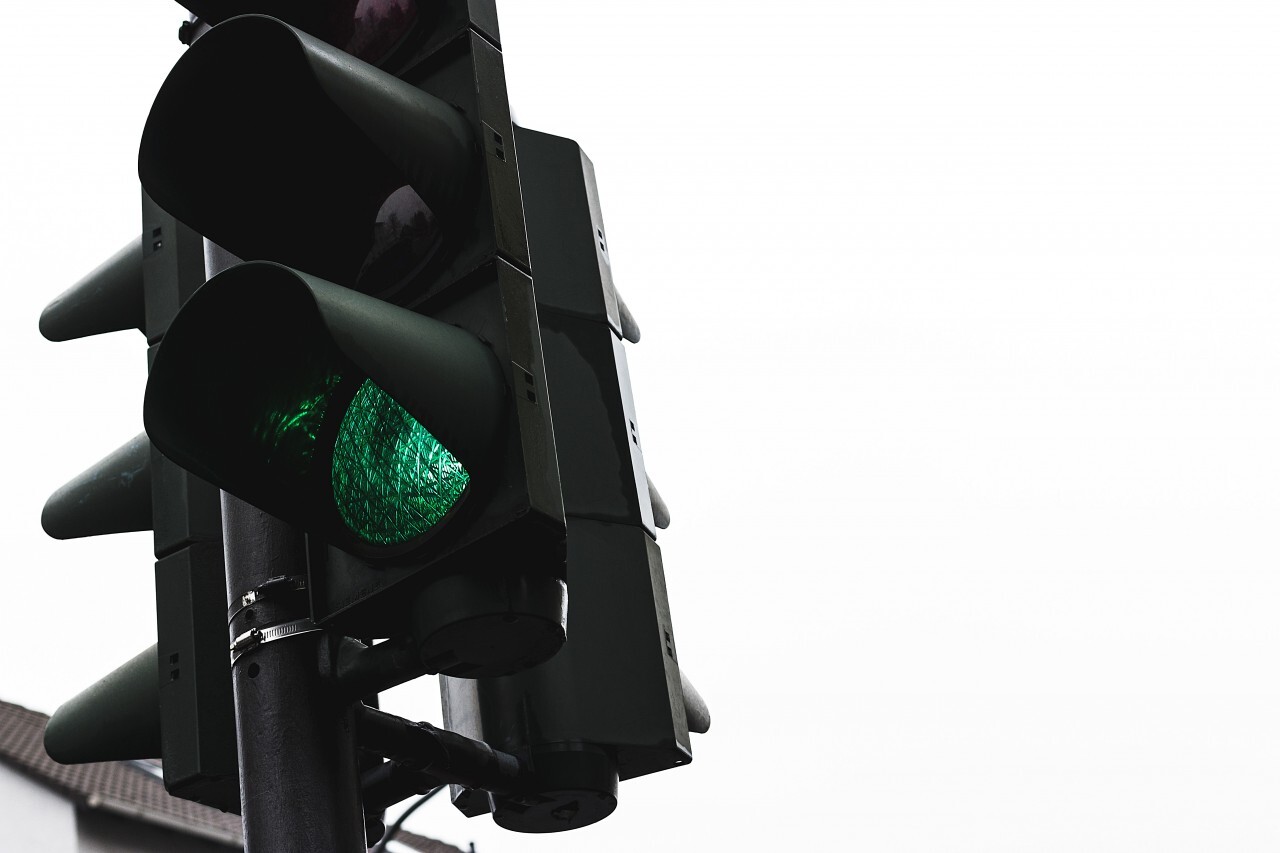 green traffic light isolated on white background