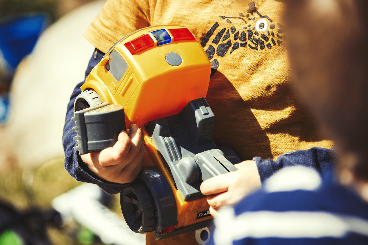 child plays with toy dipper