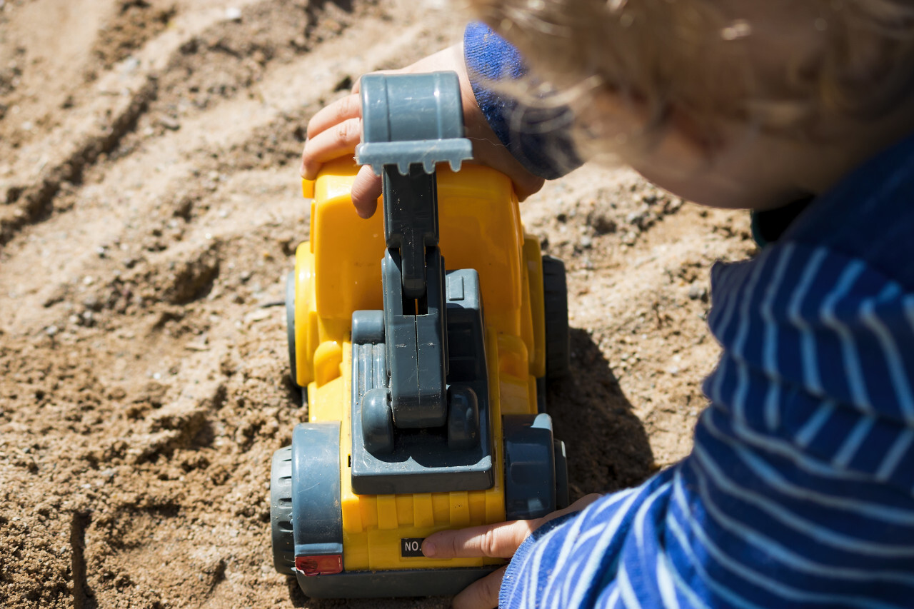 child plays with toy dipper