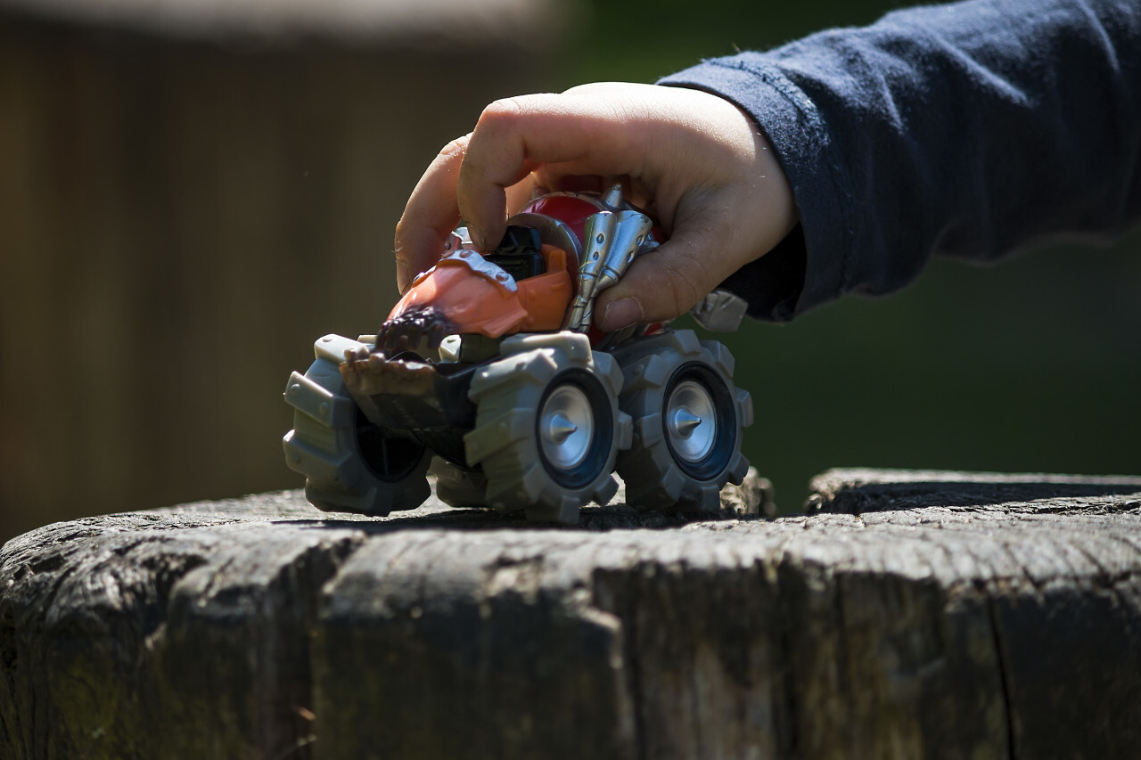 child plays with toy monster truck