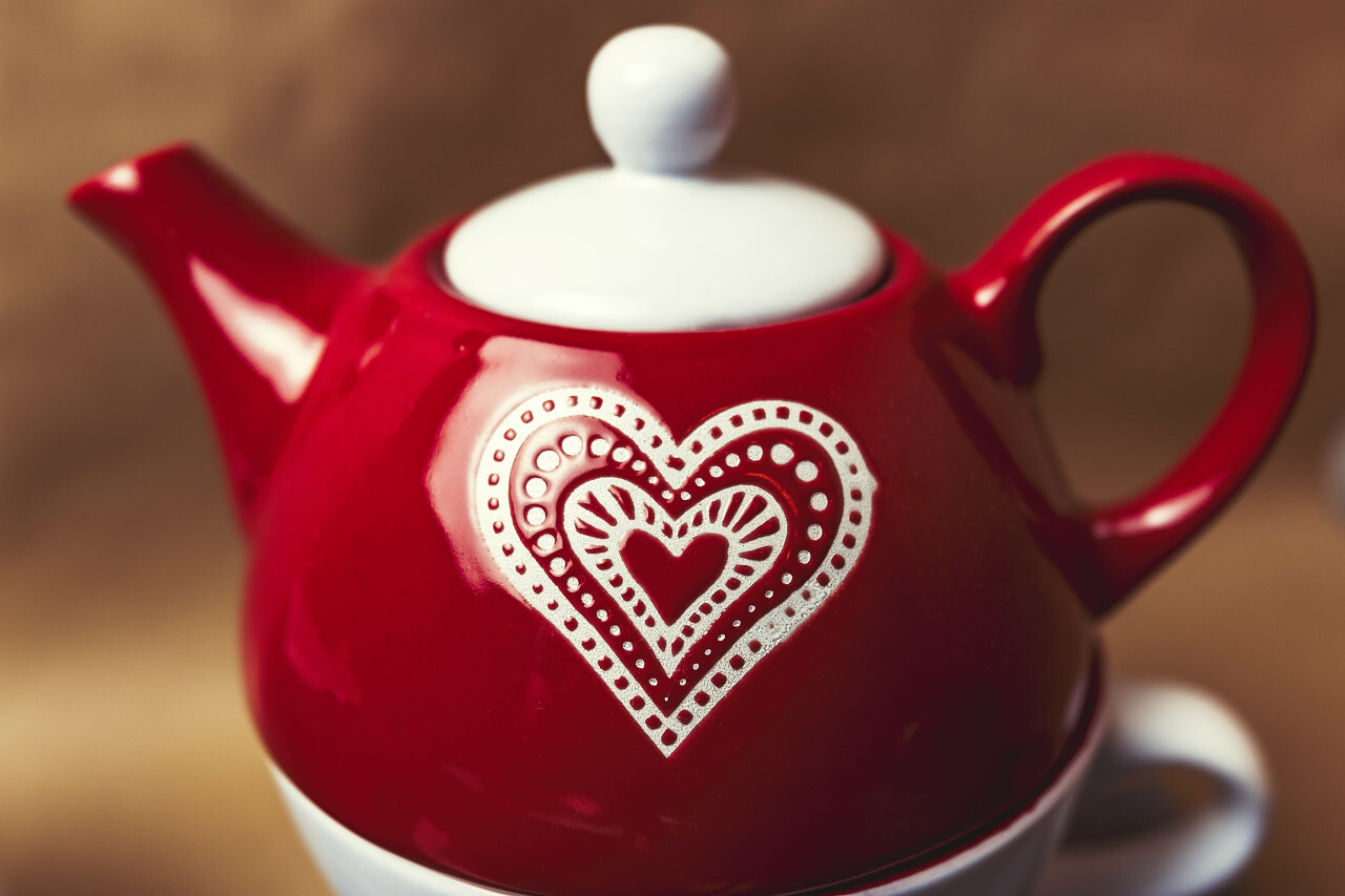 red teapot with heart