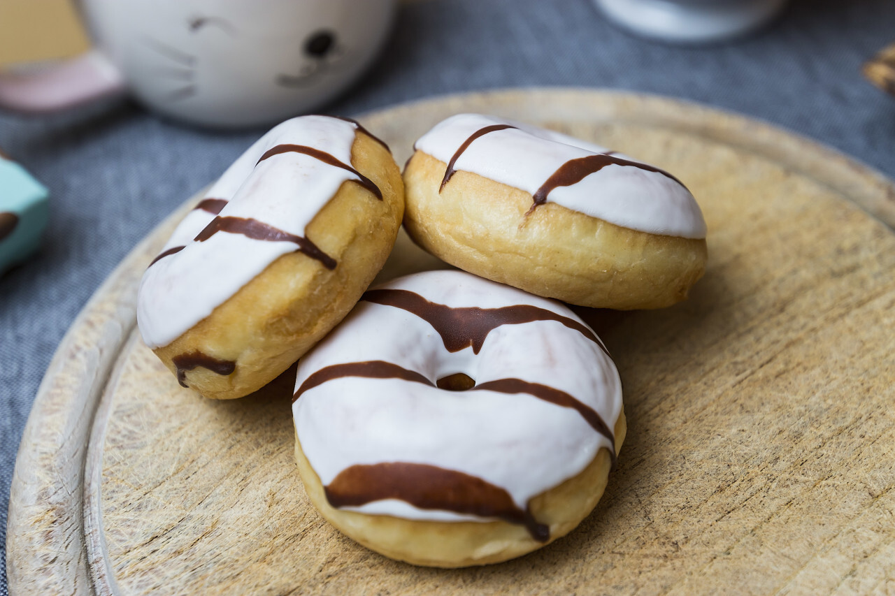 three delicious black and white striped donuts