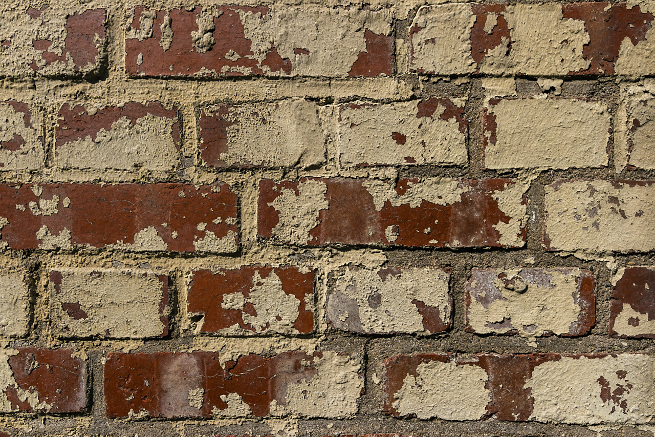 Weathered stained old brick wall