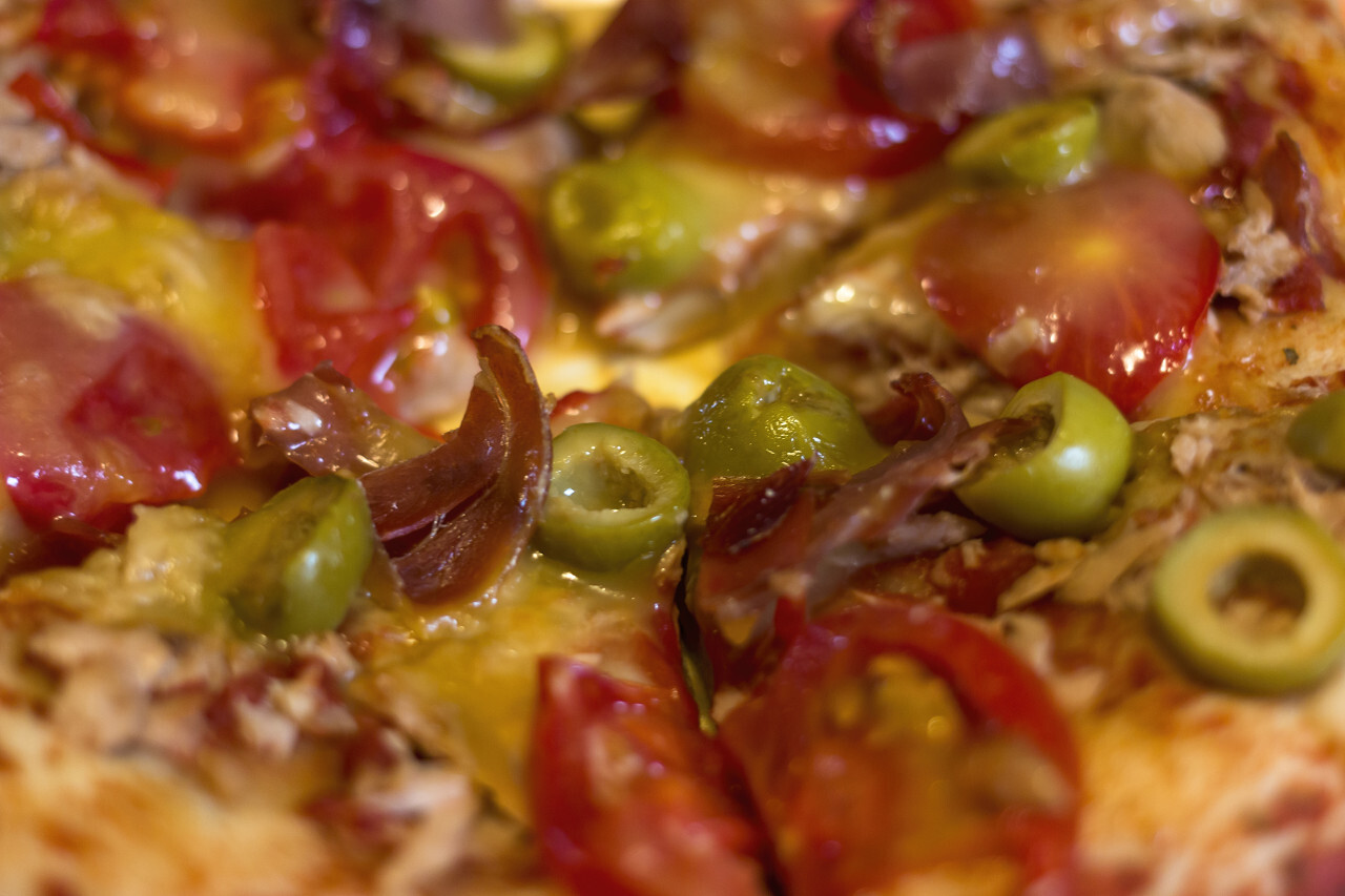 pizza with ham tomatoes and olives