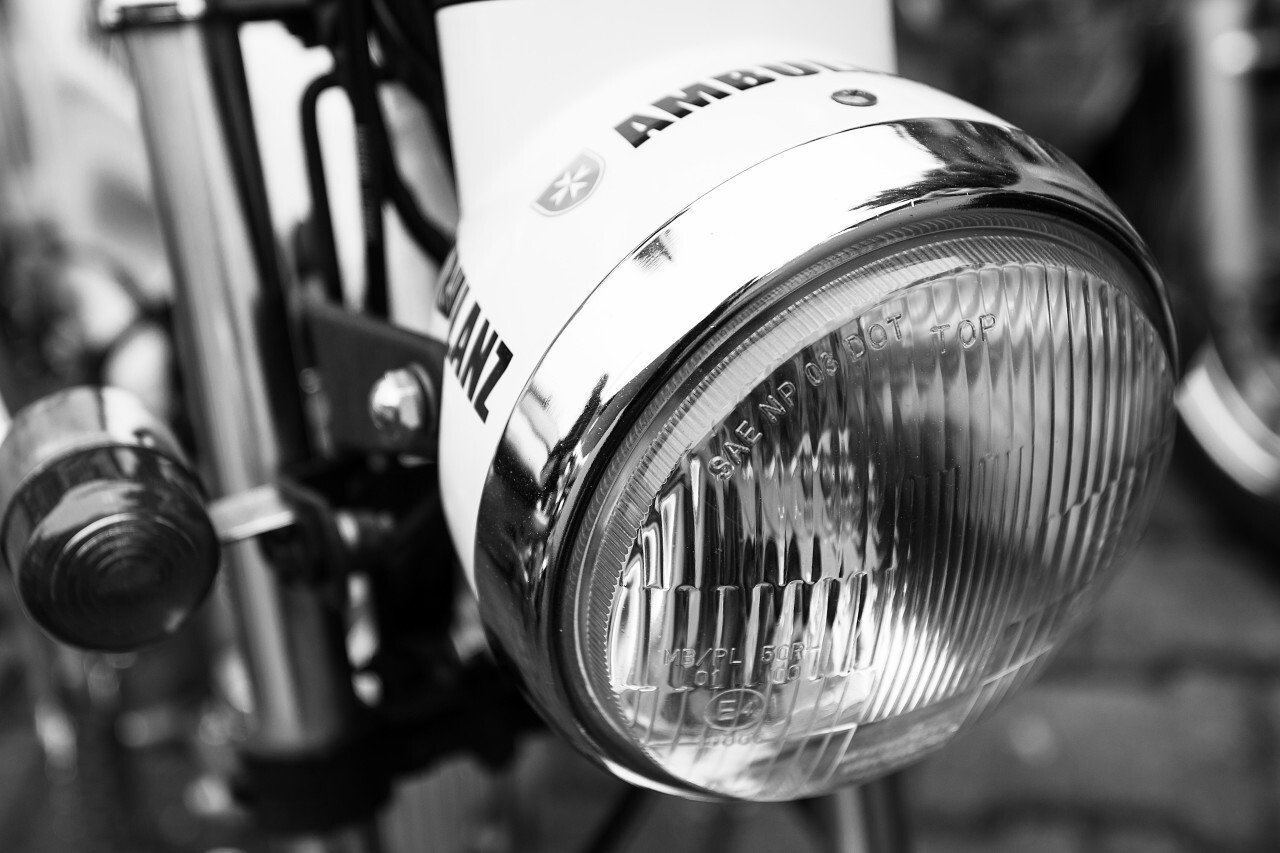 motorcycle detail shot headlight in black and white