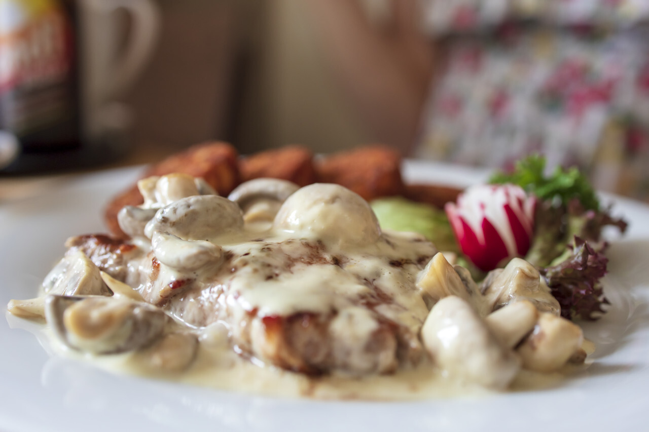 Veal steak in creamy mushroom sauce with hash browns