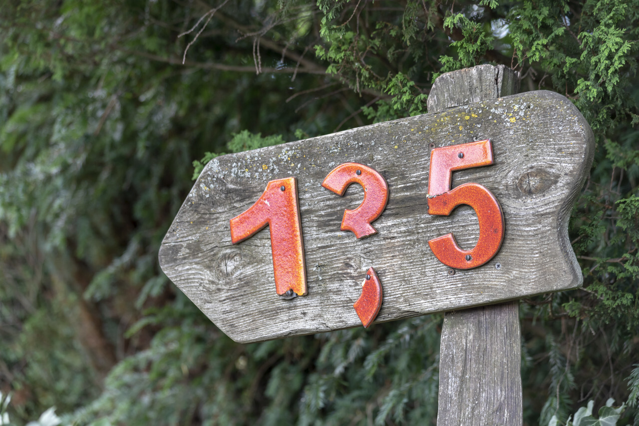 Wooden sign with the number 135
