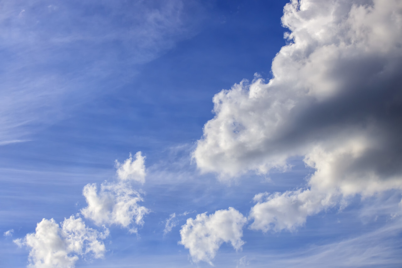 Bright beautiful blue sky with soft clouds, bright sunny day