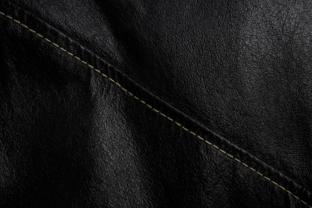 Black leather texture background with seam