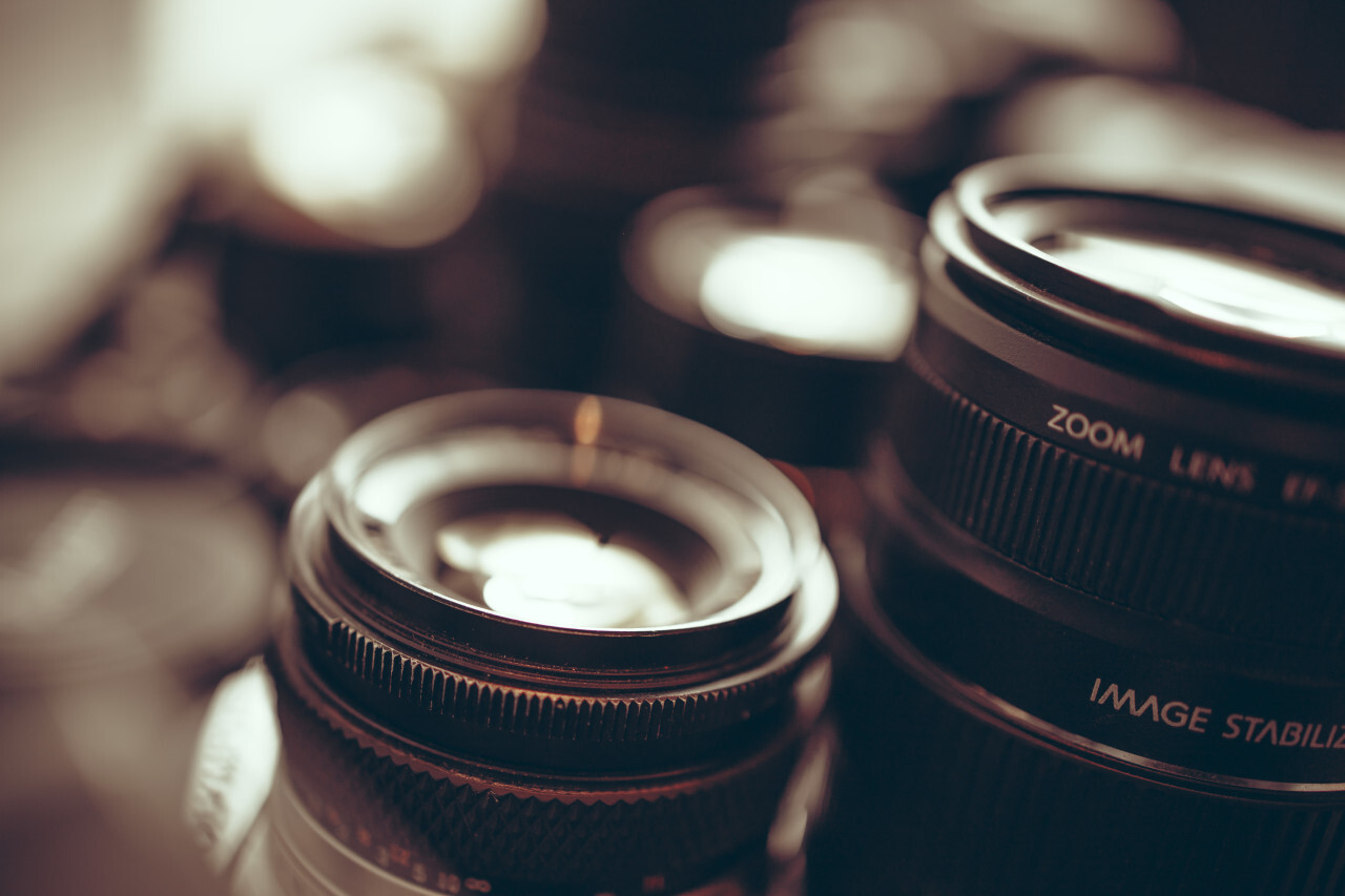 Modern and old camera lenses with reflections