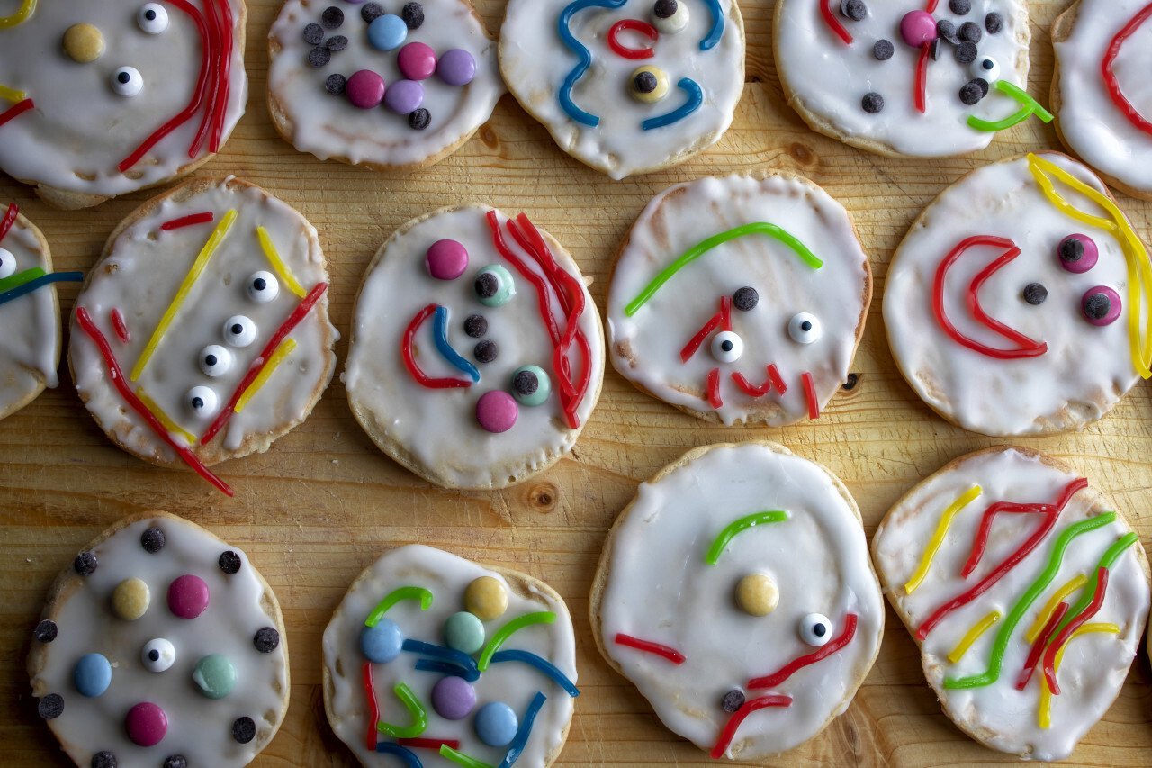 Cookies with icing decorated with colorful cute faces
