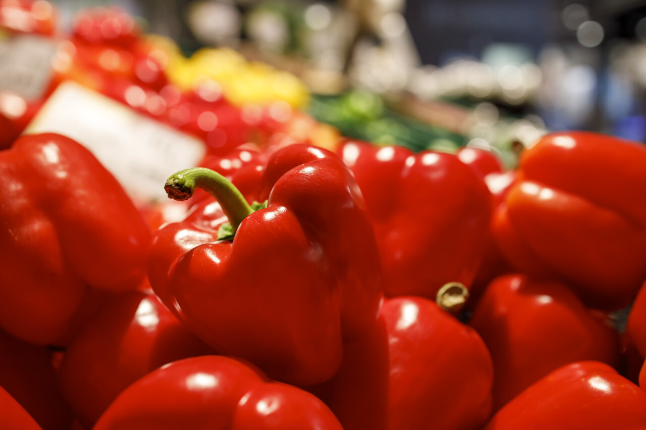 Red peppers are offered for sale in a market