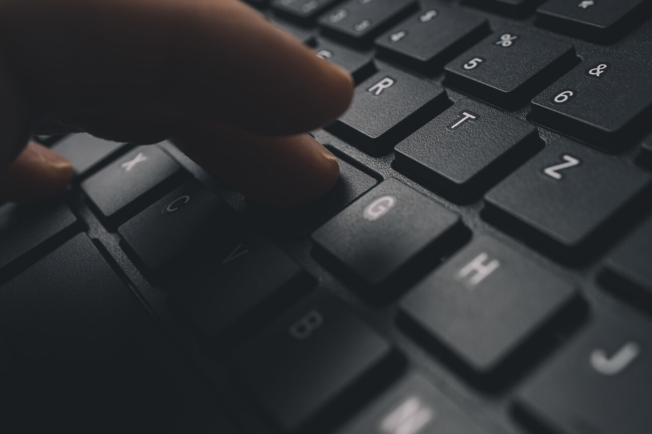 Male hands typing on computer keyboard