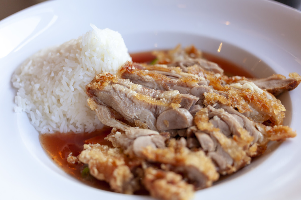 asian food with crispy duck, rice and sweet sour sauce