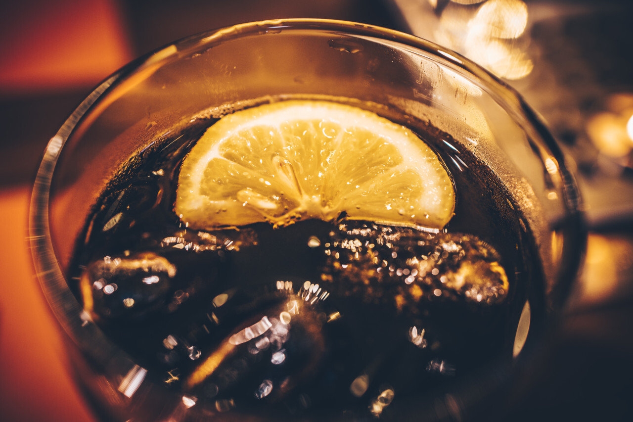 Cola with ice and lemon slice in a glass