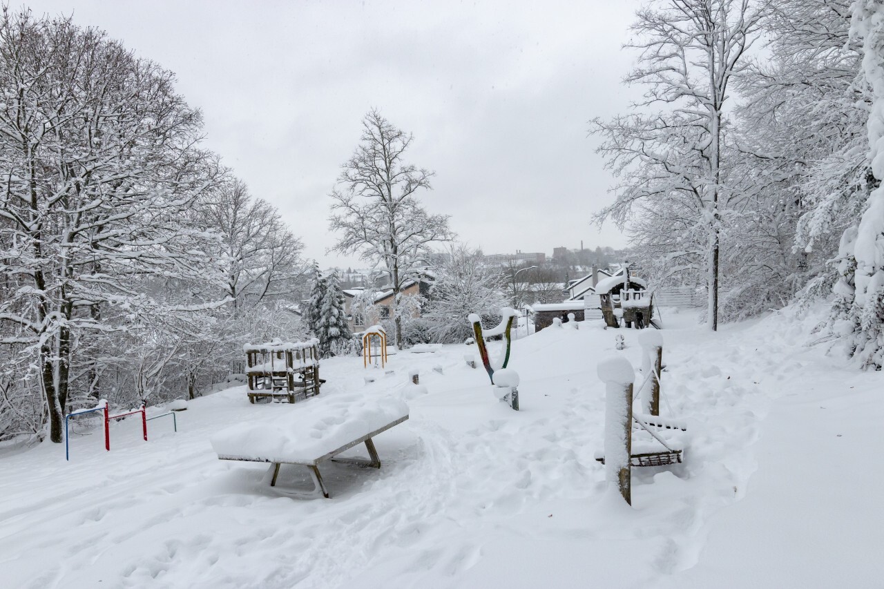 A playground completely snowed in in winter