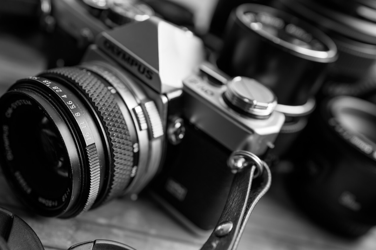 Old vintage camera and lenses on a wooden background