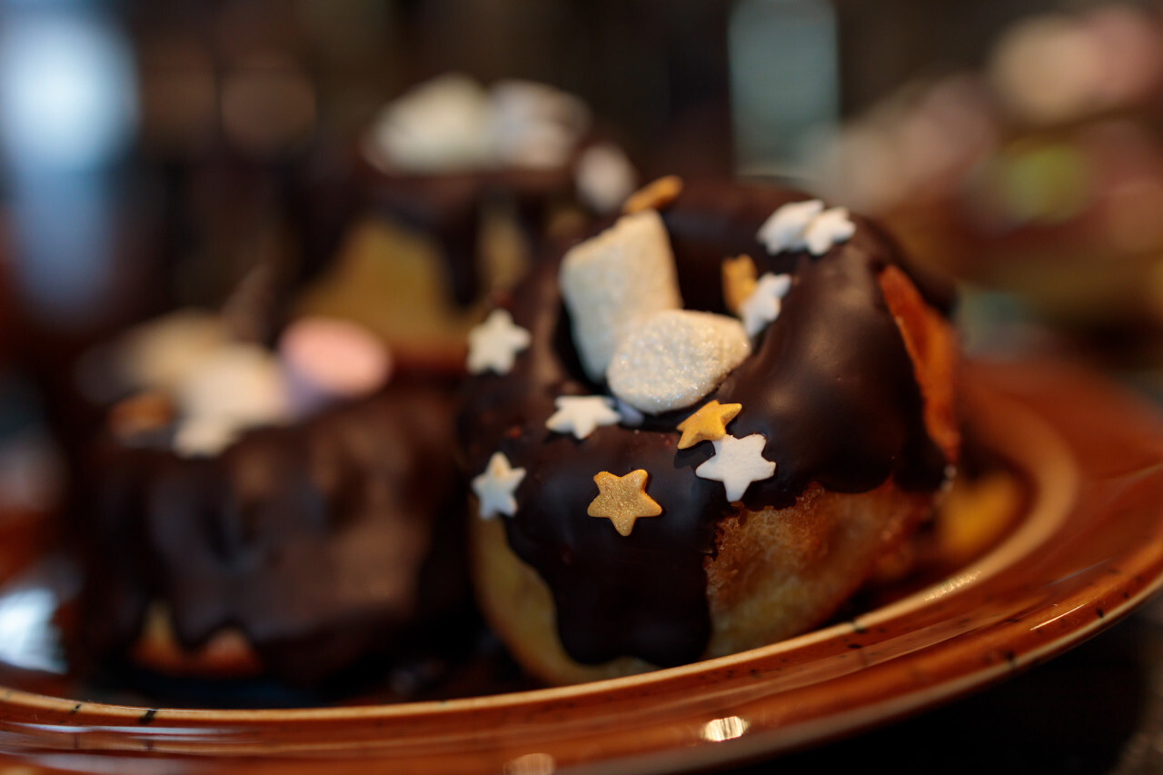 Small chocolate Cakes decorated with colored sugar stars and marshmallows