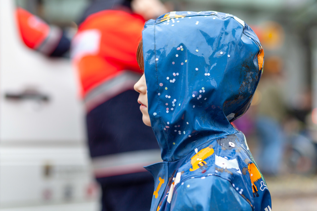 Child stands in the rain