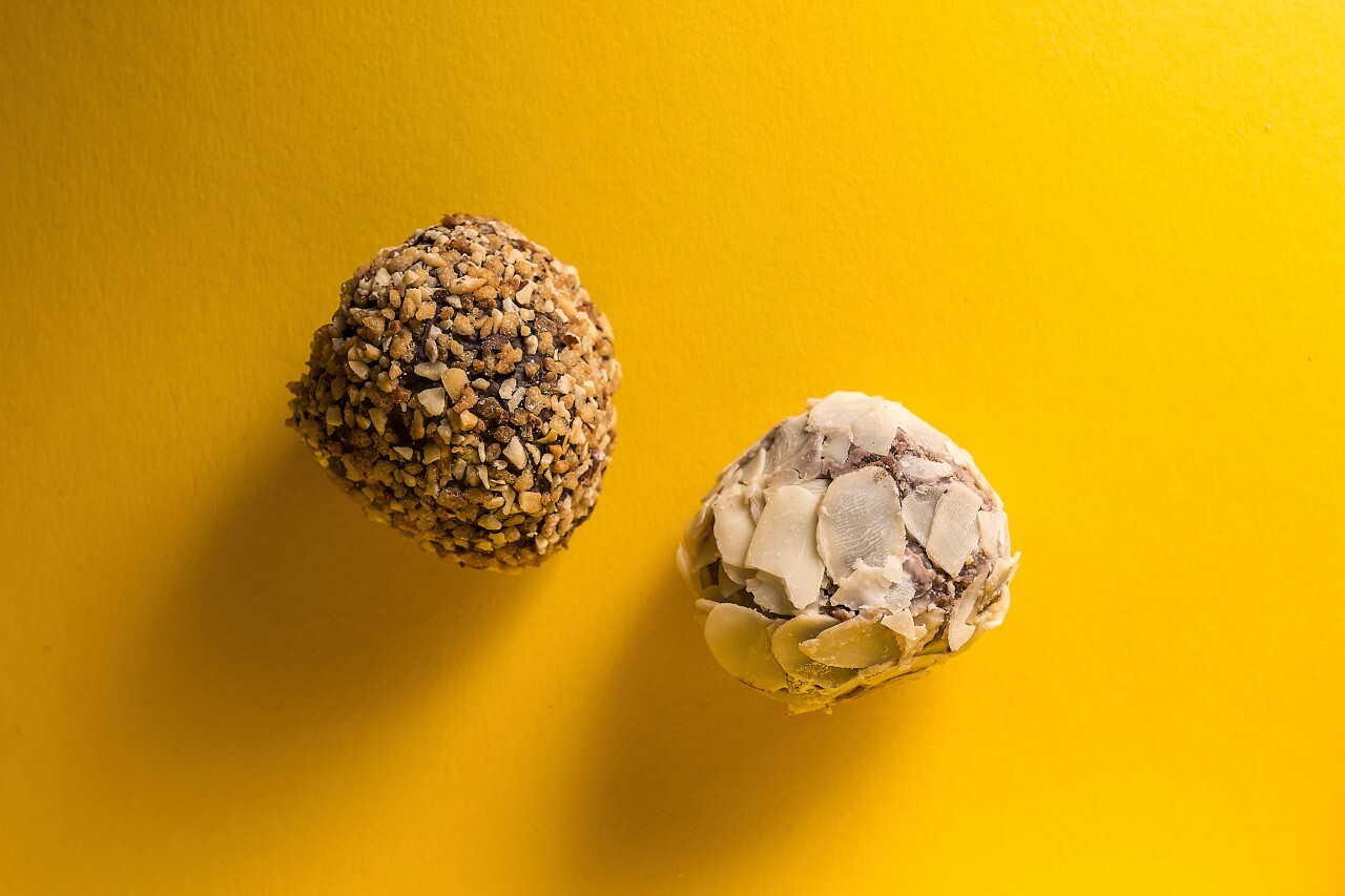 hazelnut and almond pralines on yellow background