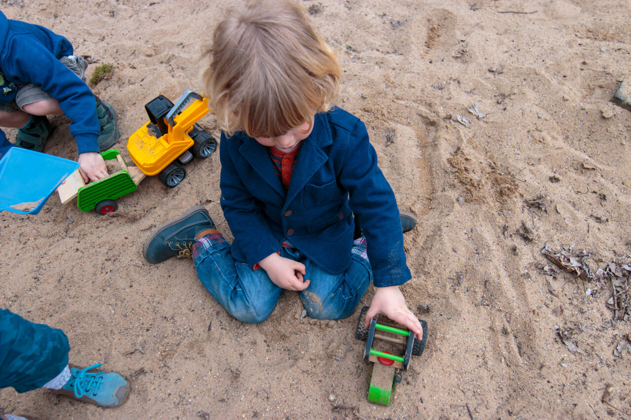 Boy plays in sandpit